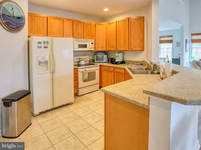 a spacious bedroom with a bed a dresser and next to a window