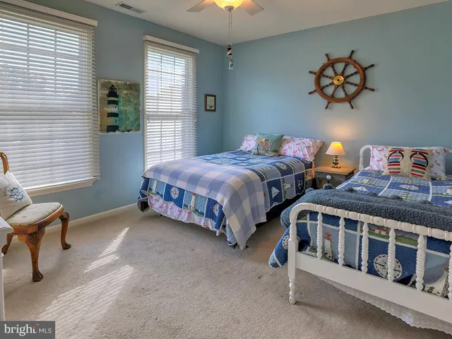 an aerial view of a house with a garden and lake view