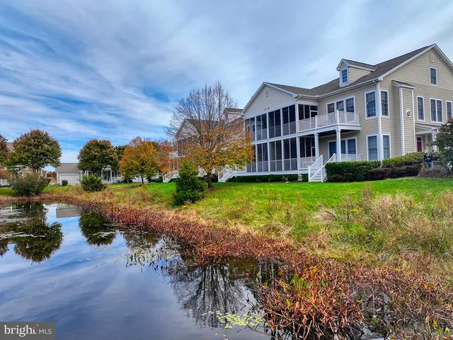 a front view of a house with a yard and tree s