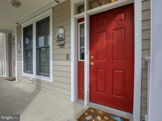 a view of a hallway with closet and a window
