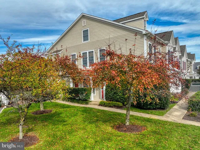 a view of a cafe with a table and chairs in front of main door