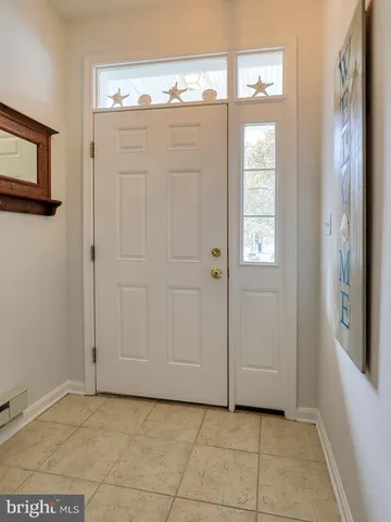 a living room with furniture a chandelier and a flat screen tv