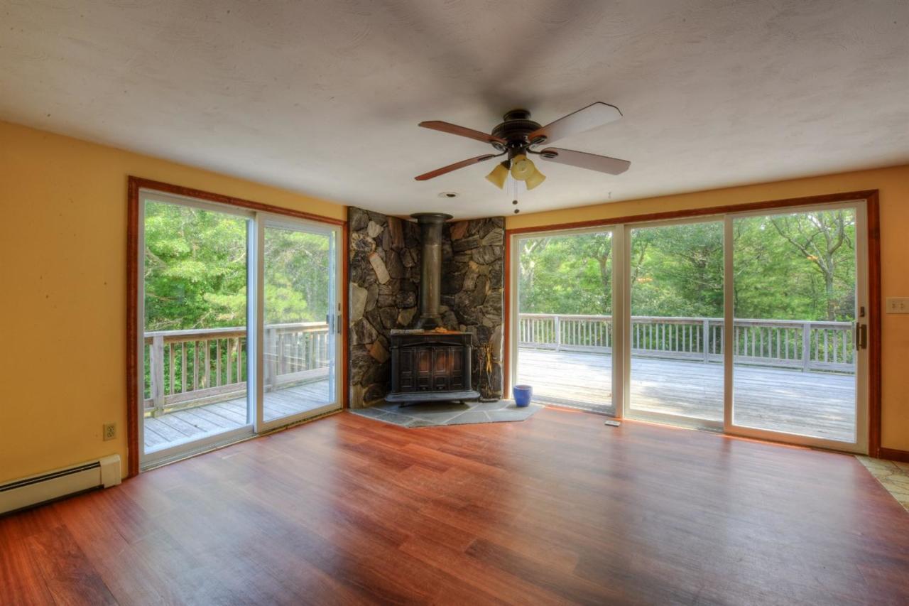 1640 Old Stage Road West Barnstable, MA 02668 - Photo 12 of 35 a view of an empty room with wooden floor and a fireplace