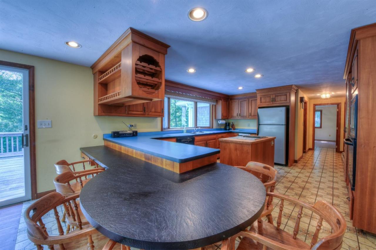 1640 Old Stage Road West Barnstable, MA 02668 - Photo 17 of 35 a living room with furniture a table and kitchen view