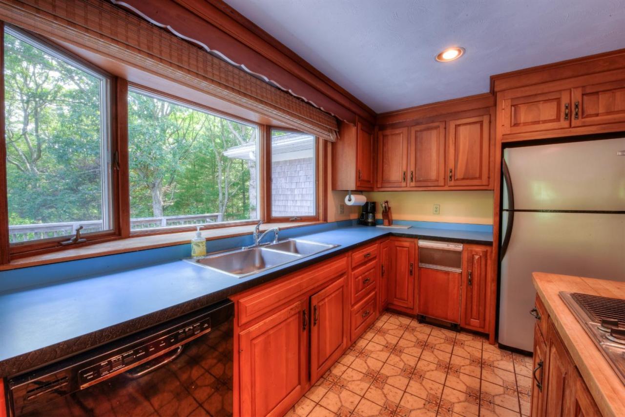 1640 Old Stage Road West Barnstable, MA 02668 - Photo 18 of 35 a kitchen with stainless steel appliances granite countertop a refrigerator a sink and a stove