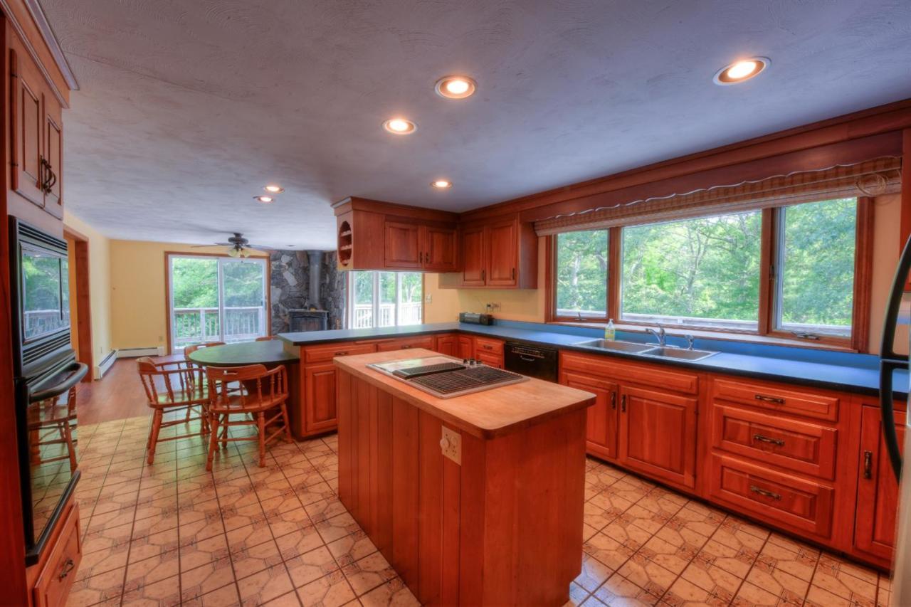 1640 Old Stage Road West Barnstable, MA 02668 - Photo 19 of 35 a kitchen with stainless steel appliances granite countertop sink stove top oven and cabinets