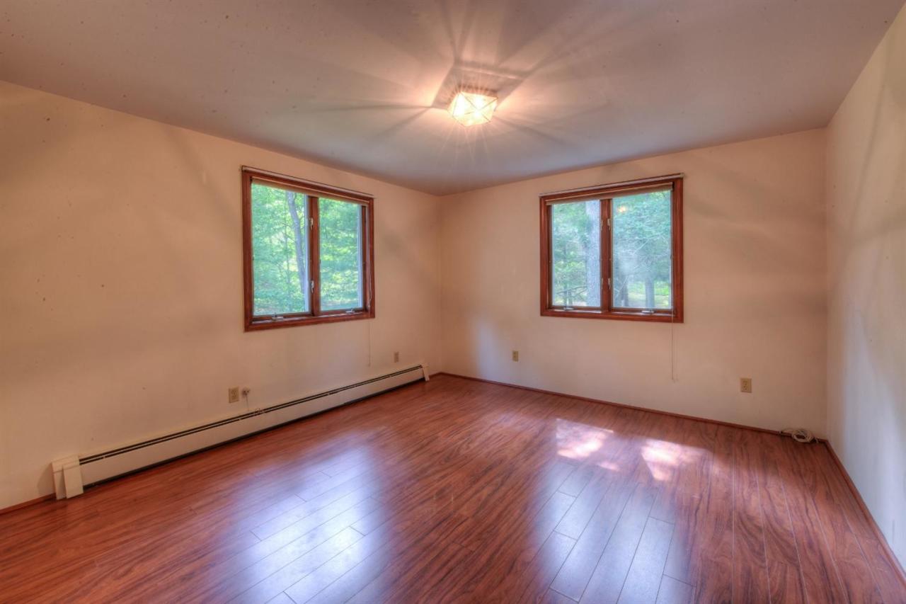 1640 Old Stage Road West Barnstable, MA 02668 - Photo 23 of 35 a view of an empty room with wooden floor and a window