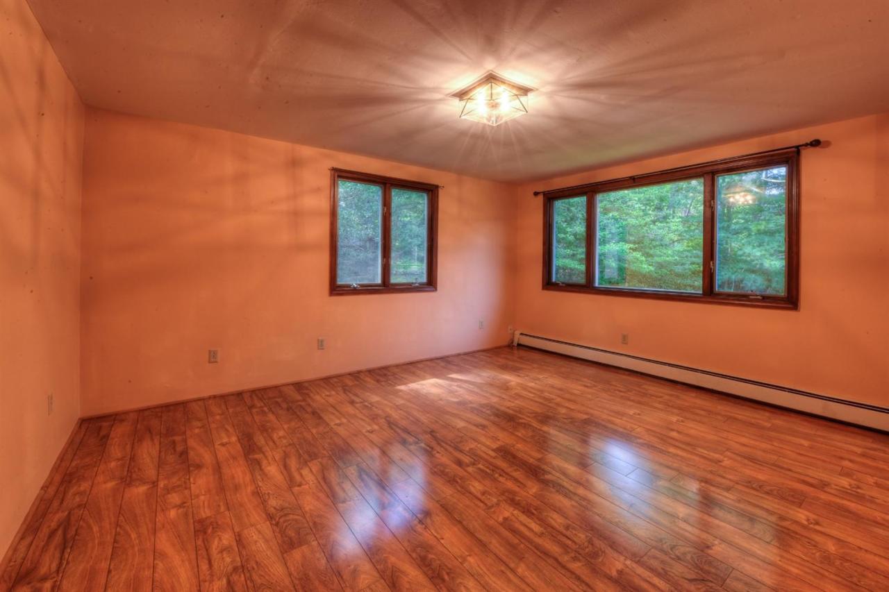 1640 Old Stage Road West Barnstable, MA 02668 - Photo 24 of 35 a view of an empty room with wooden floor and a window