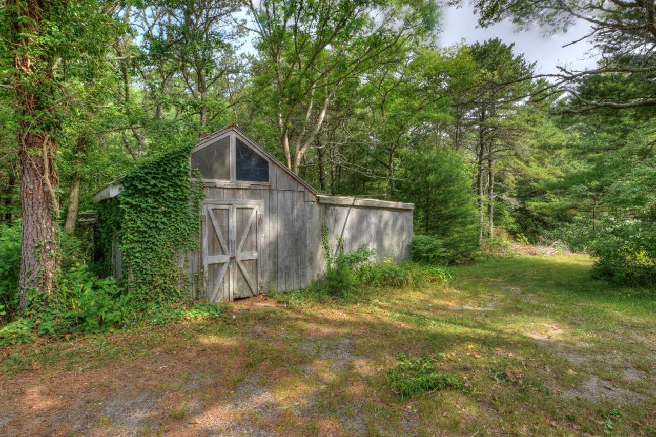 1640 Old Stage Road West Barnstable, MA 02668 - Photo 29 of 35 a backyard of a house with plants and large trees
