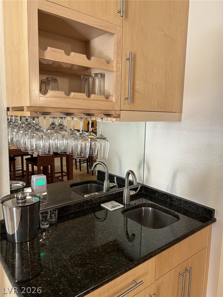 210 East Flamingo Road, Unit 137 Las Vegas, NV 89169 - Photo 6 of 32 Granite counters and dual sinks define this wet bar, perfect for entertaining guests.