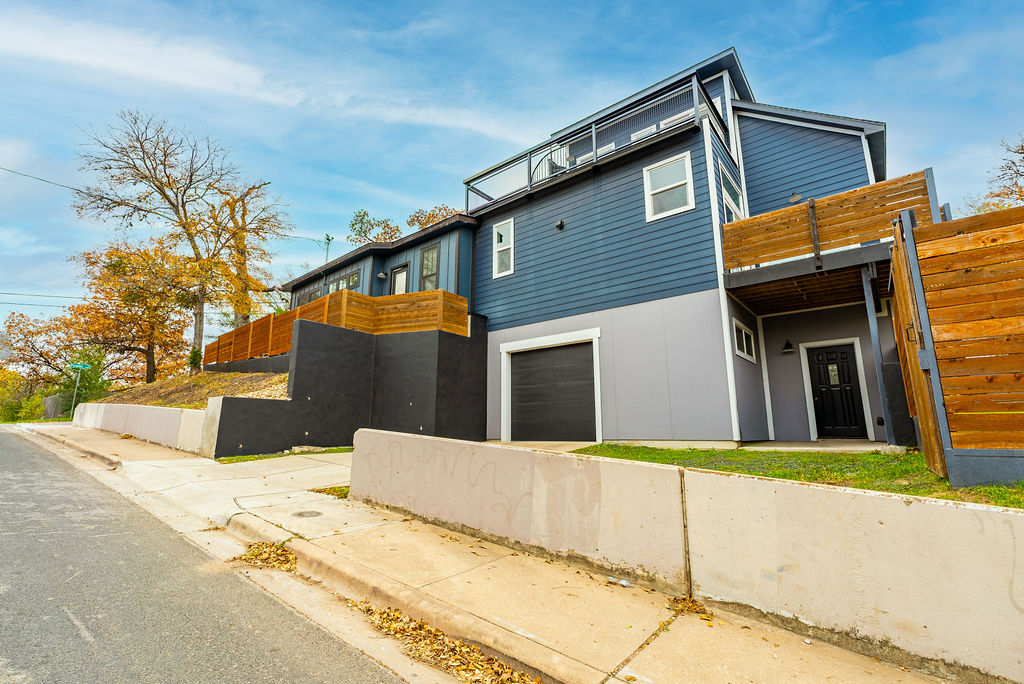 View of property exterior featuring an attached garage and concrete driveway