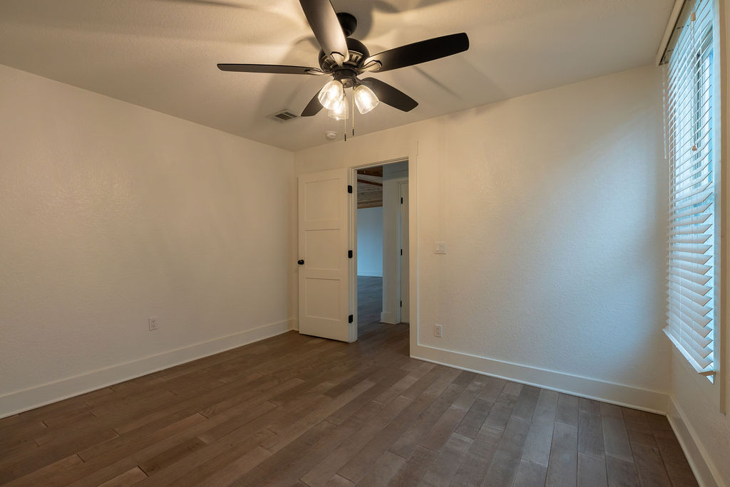 2016 Peoples Street Austin, TX 78702 - Photo 15 of 28 Unfurnished bedroom with dark wood-style floors and a ceiling fan