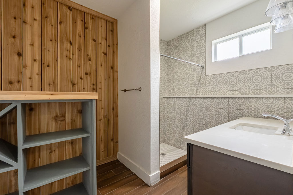 2016 Peoples Street Austin, TX 78702 - Photo 17 of 28 Full bathroom with wood tiled floors, tiled shower, and vanity