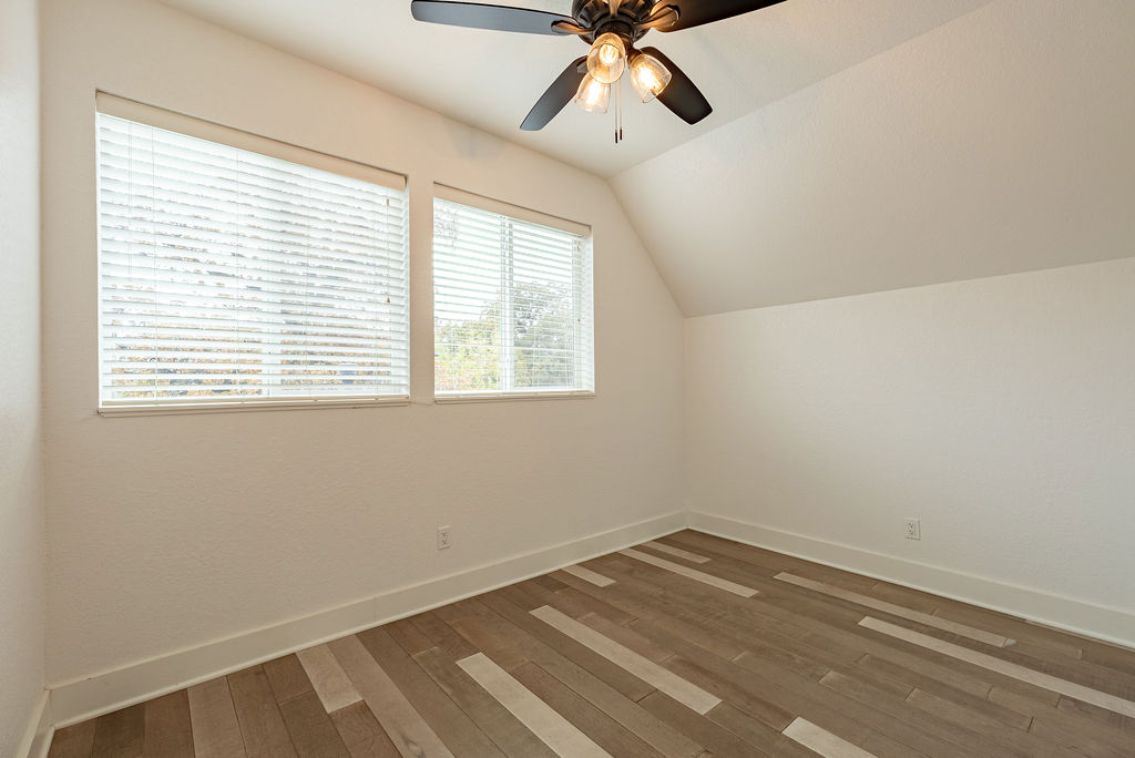 2016 Peoples Street Austin, TX 78702 - Photo 21 of 28 Additional living space featuring vaulted ceiling, dark wood-type flooring, and a ceiling fan
