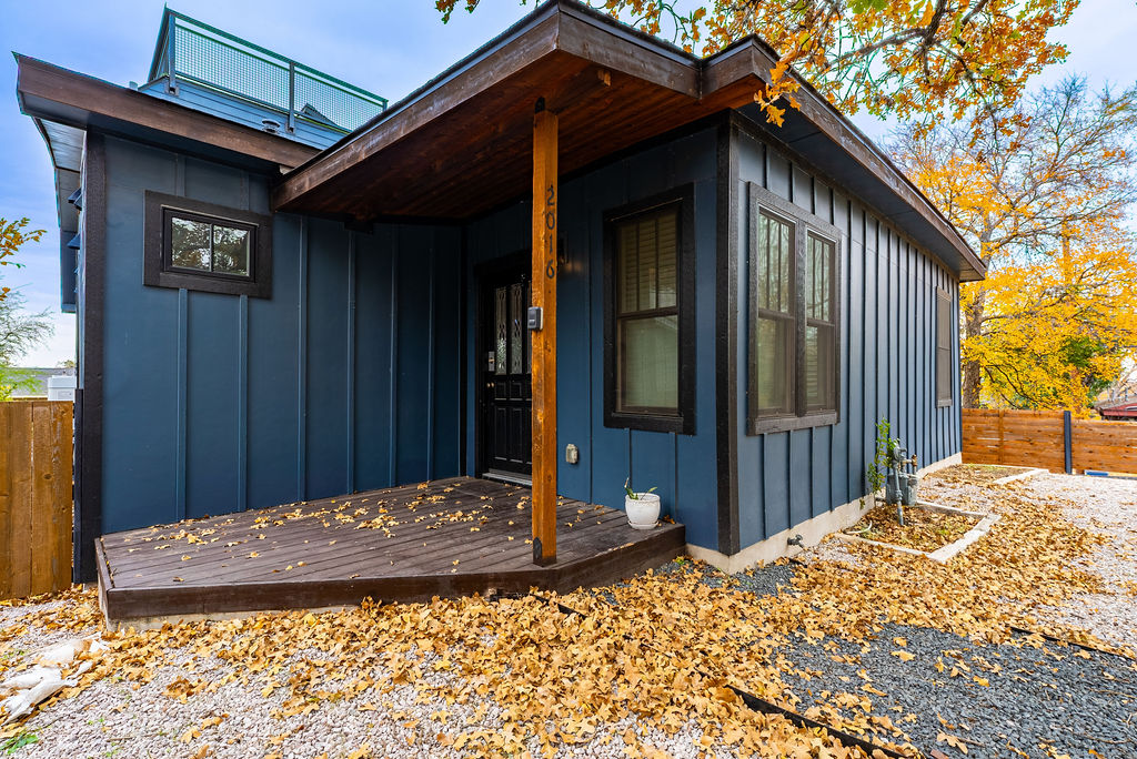 2016 Peoples Street Austin, TX 78702 - Photo 27 of 28 View of side of property featuring board and batten siding and a wooden deck