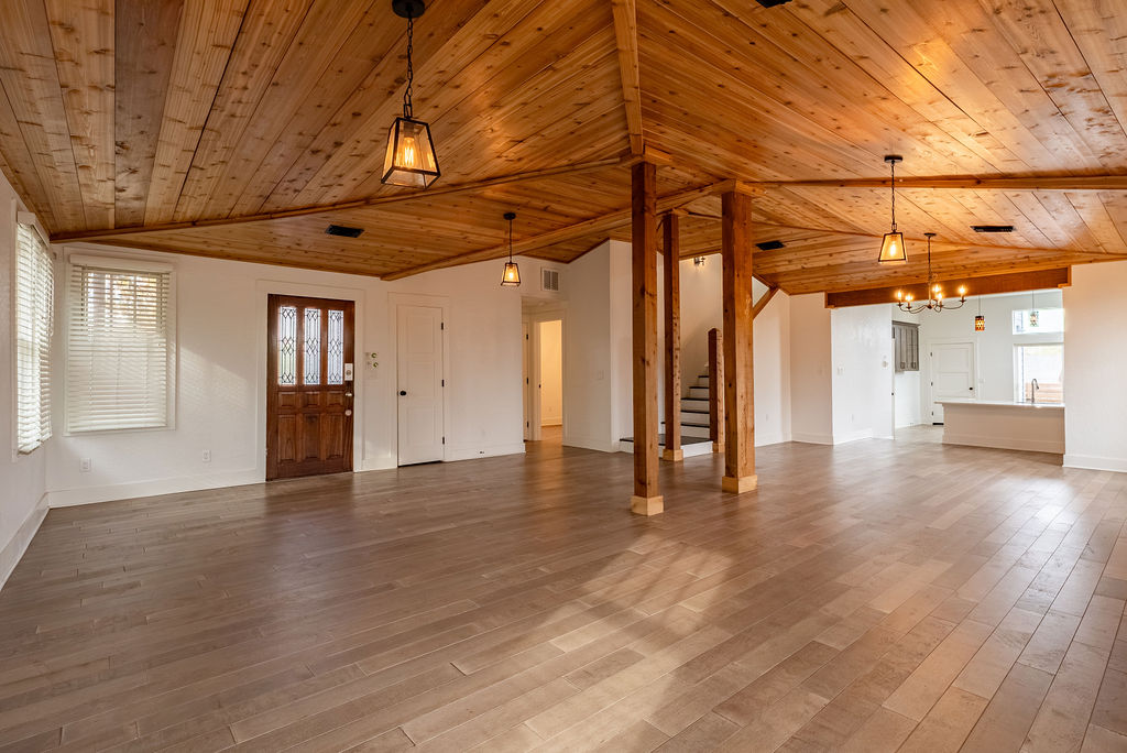 2016 Peoples Street Austin, TX 78702 - Photo 3 of 28 Unfurnished living room featuring wooden ceiling, stairs, light wood finished floors, and lofted ceiling