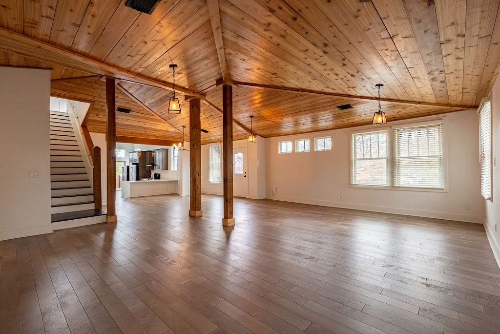 2016 Peoples Street Austin, TX 78702 - Photo 4 of 28 Unfurnished living room with wood ceiling, lofted ceiling, stairs, and light wood-type flooring