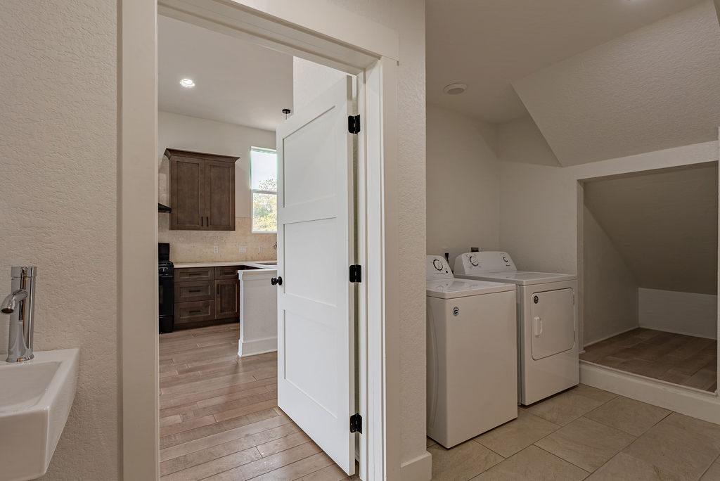 2016 Peoples Street Austin, TX 78702 - Photo 10 of 28 Laundry room with a textured wall, light wood-type flooring, independent washer and dryer, and recessed lighting