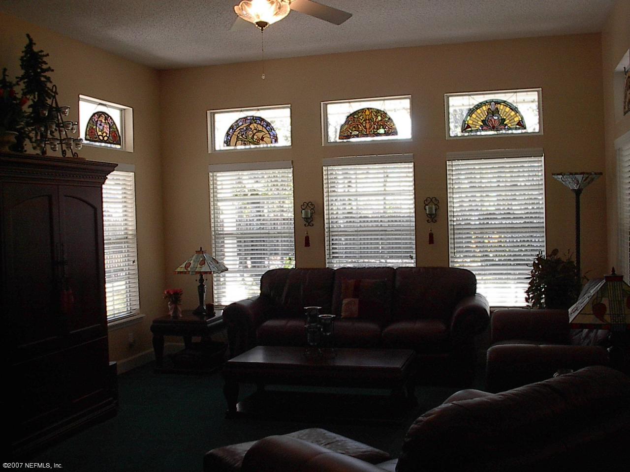 11382 Mandarin Ridge Lane Jacksonville, FL 32258 - Photo 16 of 23 a living room with furniture and large windows