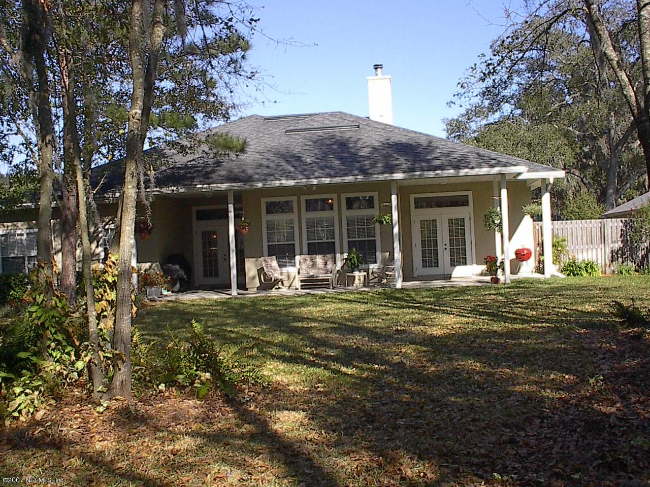 11382 Mandarin Ridge Lane Jacksonville, FL 32258 - Photo 19 of 23 a front view of a house with a garden and porch