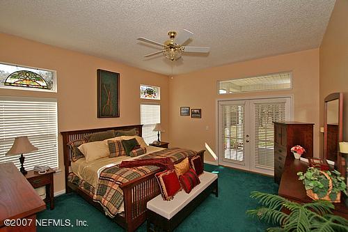 11382 Mandarin Ridge Lane Jacksonville, FL 32258 - Photo 20 of 23 a bedroom with a bed dresser flowerpot and window