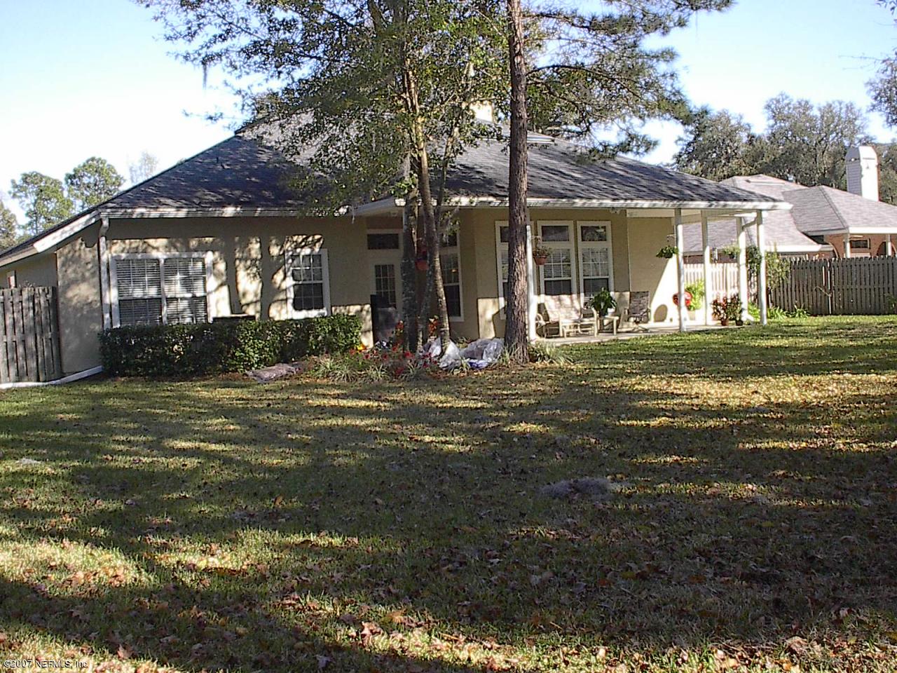 11382 Mandarin Ridge Lane Jacksonville, FL 32258 - Photo 21 of 23 a front view of a house with a garden