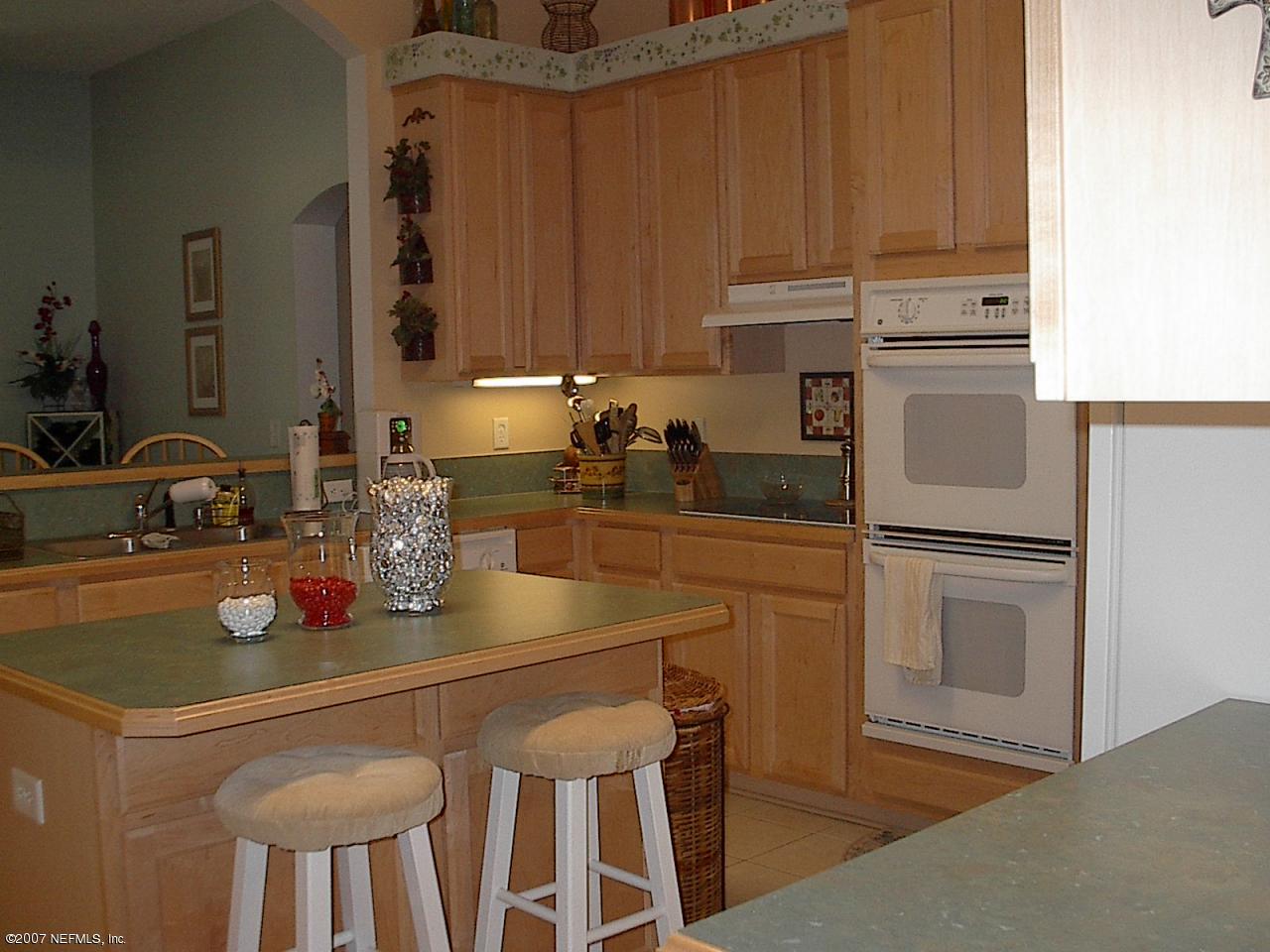 11382 Mandarin Ridge Lane Jacksonville, FL 32258 - Photo 8 of 23 a kitchen with stainless steel appliances a sink cabinets and wooden floor