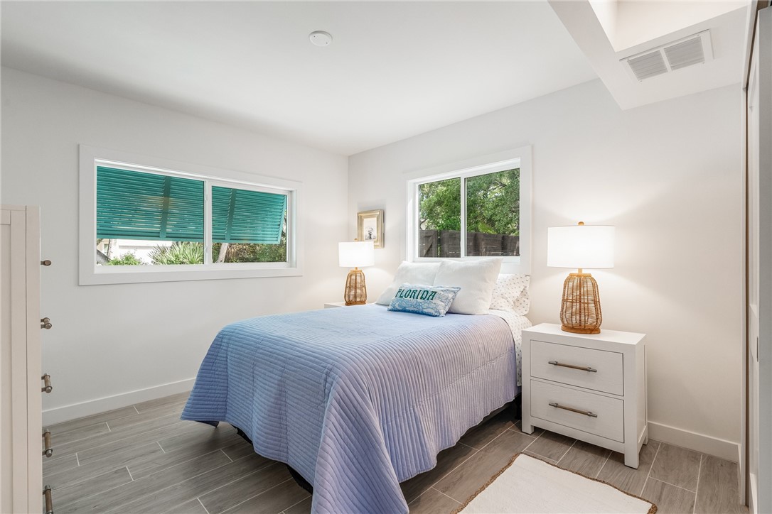 1881 Pebble Path Vero Beach, FL 32963 - Photo 21 of 34 a bedroom with a bed wooden floor and window