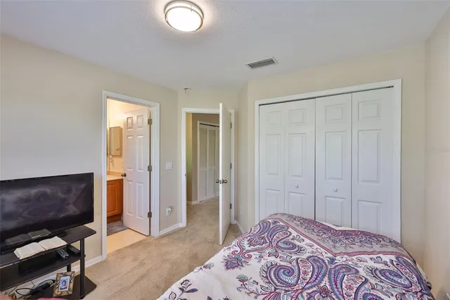 a bathroom with a granite countertop sink toilet and mirror