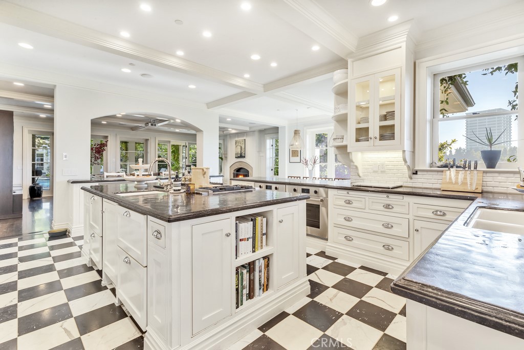 27 Burning Tree Circle Newport Beach, CA 92660 - Photo 21 of 50 a kitchen with granite countertop a sink and cabinets