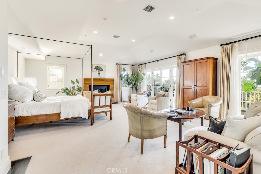 27 Burning Tree Circle Newport Beach, CA 92660 - Photo 32 of 50 a living room with furniture and a fireplace