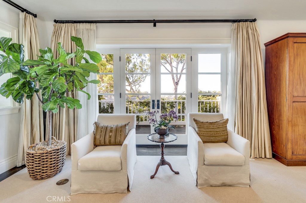 27 Burning Tree Circle Newport Beach, CA 92660 - Photo 33 of 50 a living room with furniture and a large window