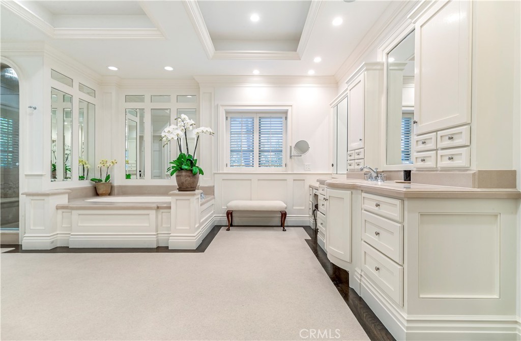 27 Burning Tree Circle Newport Beach, CA 92660 - Photo 37 of 50 a spacious en suite bathroom with a double vanity sink large mirror and a bathtub