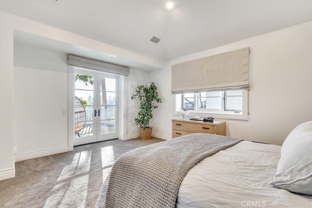 27 Burning Tree Circle Newport Beach, CA 92660 - Photo 46 of 50 a bedroom with a large bed and a window