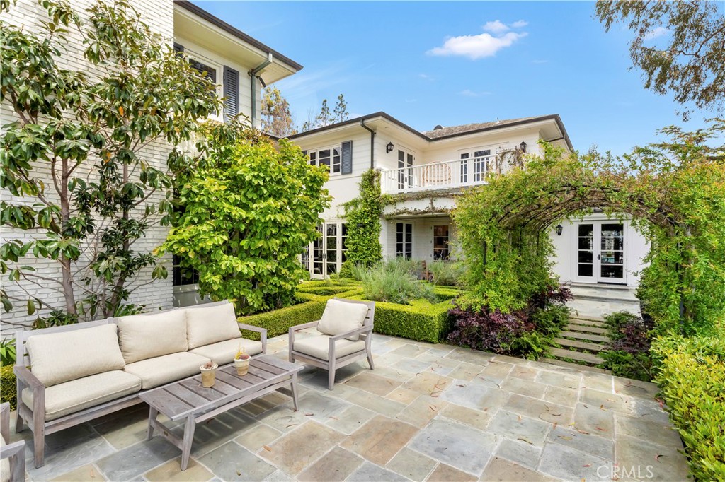 27 Burning Tree Circle Newport Beach, CA 92660 - Photo 7 of 50 a view of a patio with couches table and chairs and potted plants