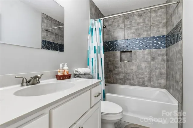 a bedroom with a large bed and a ceiling fan