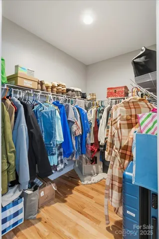 a view of a hallway with wooden floor and windows