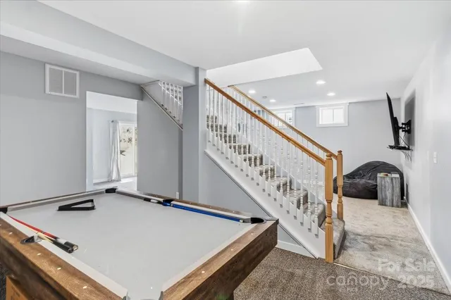 a bedroom with bed tv and glass door