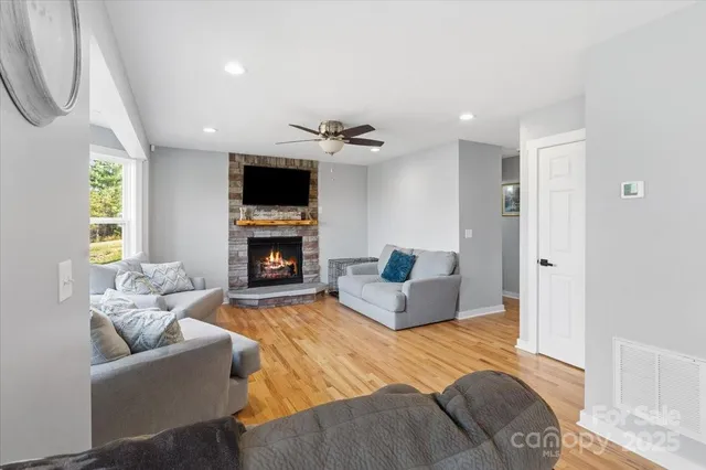 a living room with furniture flat screen tv and a fireplace