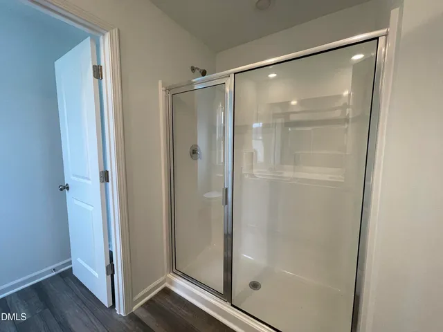 a bathroom with a glass shower door