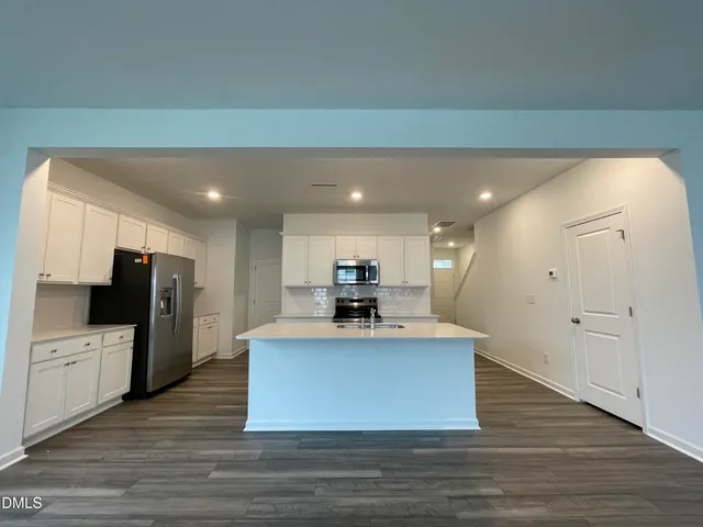 a view of kitchen with sink microwave and refrigerator