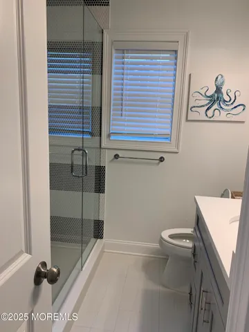 a bathroom with a toilet and a shower