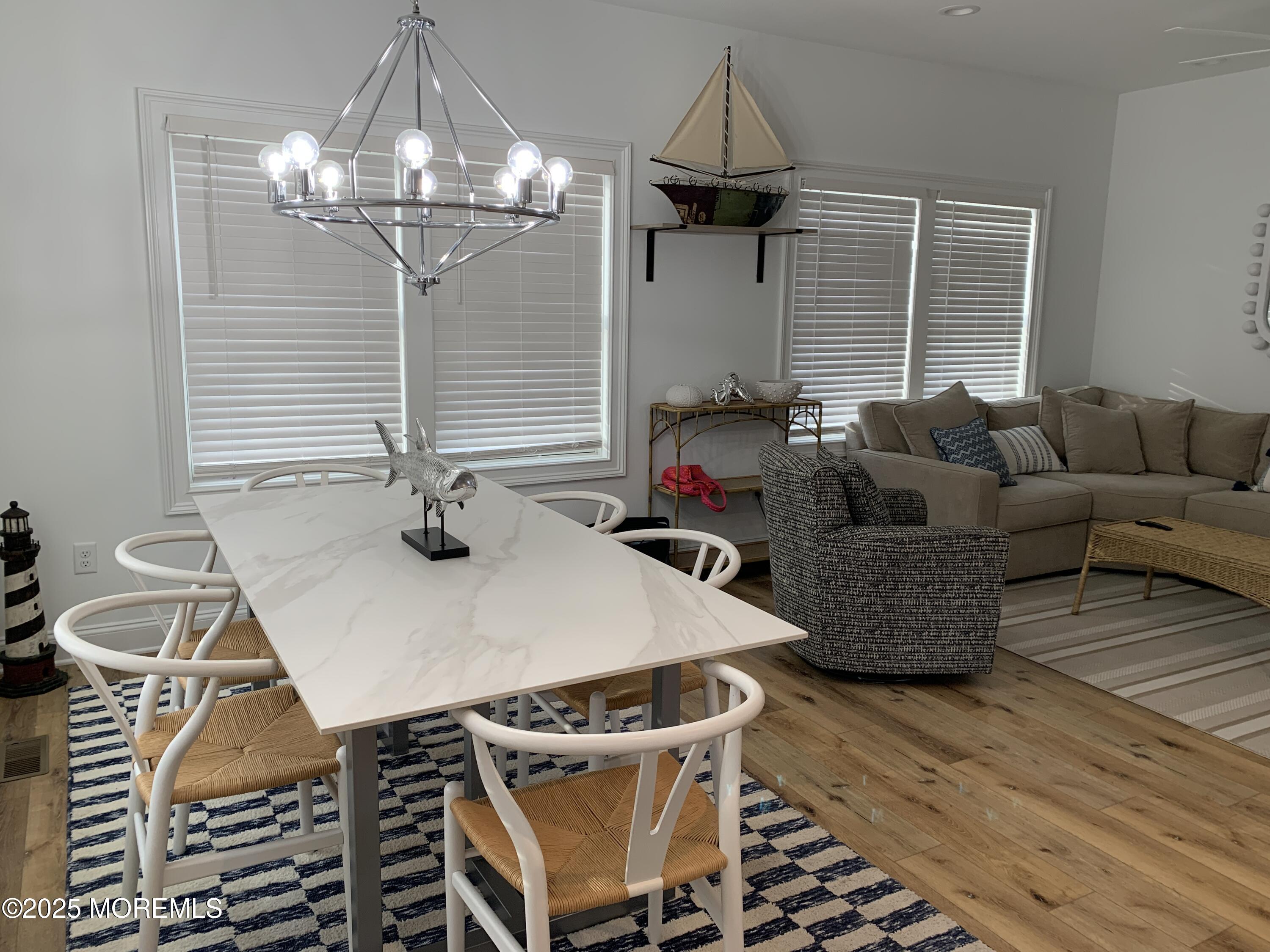 72 Spray Way Lavallette, NJ 08735 - Photo 3 of 14 a living room with furniture a chandelier and a dining table
