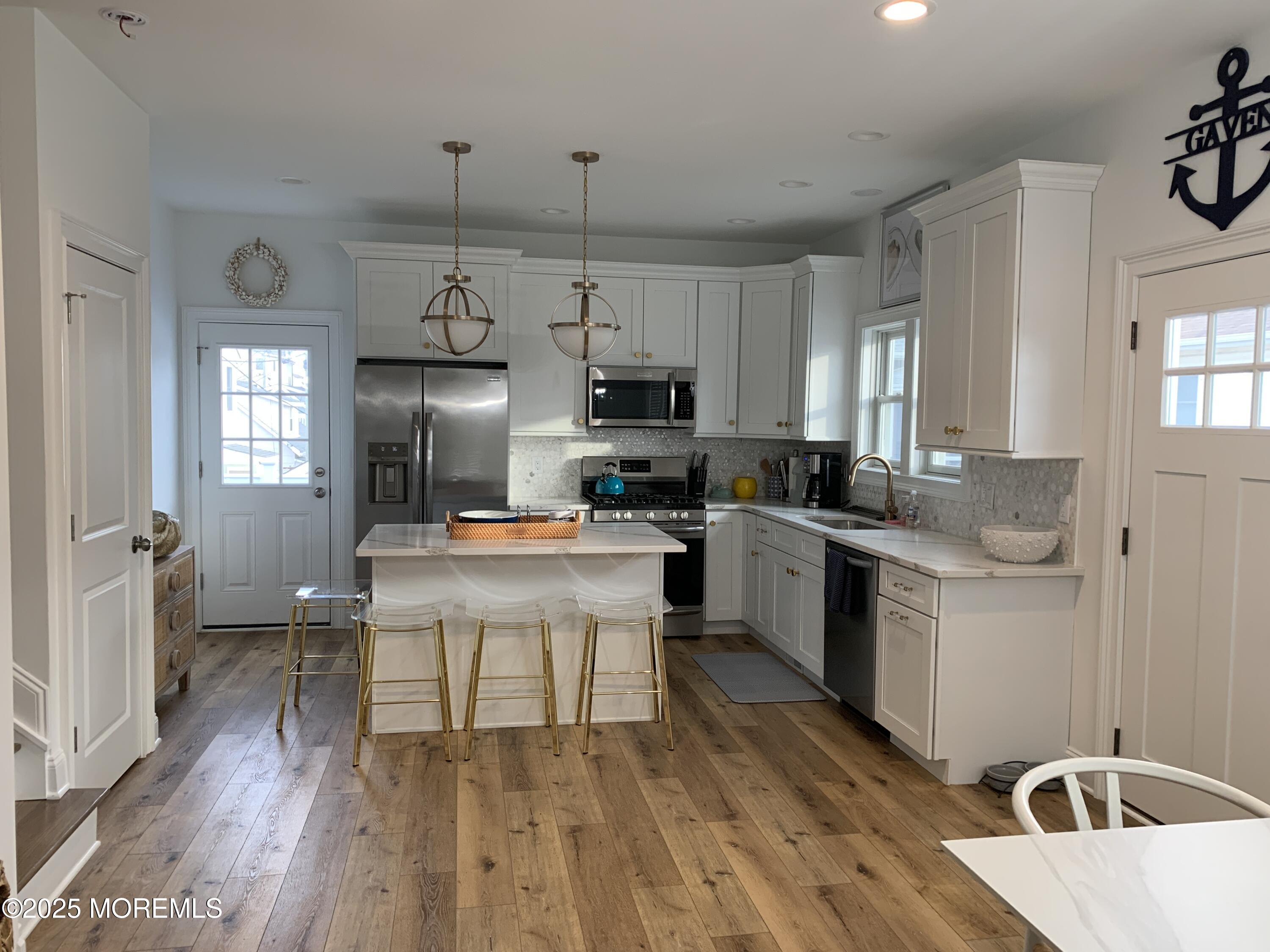 72 Spray Way Lavallette, NJ 08735 - Photo 5 of 14 a kitchen with cabinets a sink a window and stainless steel appliances