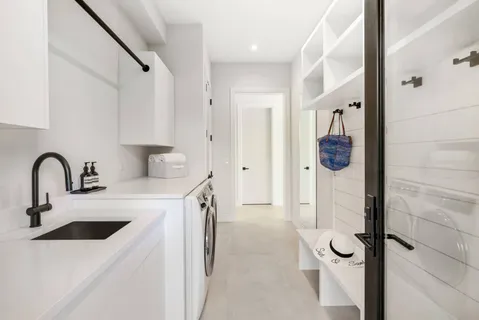 a view of a kitchen with a sink and refrigerator