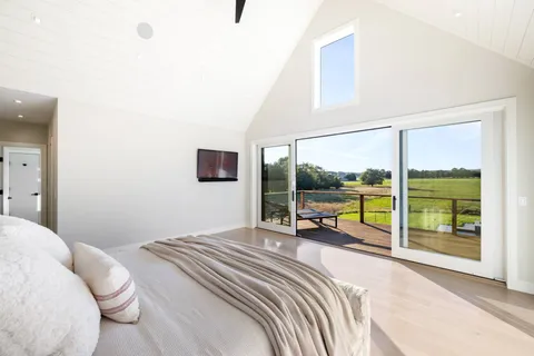 a bedroom with a bed and glass door