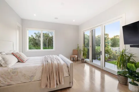 a bedroom with a bed and a large window