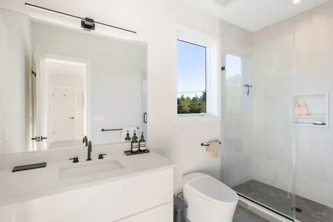 a bathroom with a sink toilet and shower