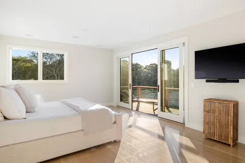 a bedroom with a bed and a flat screen tv