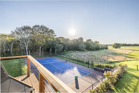 a view of a balcony with yard and lake view